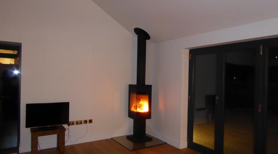 Log burner adding a touch of winter cosiness alongside the lounge bi-fold doors
