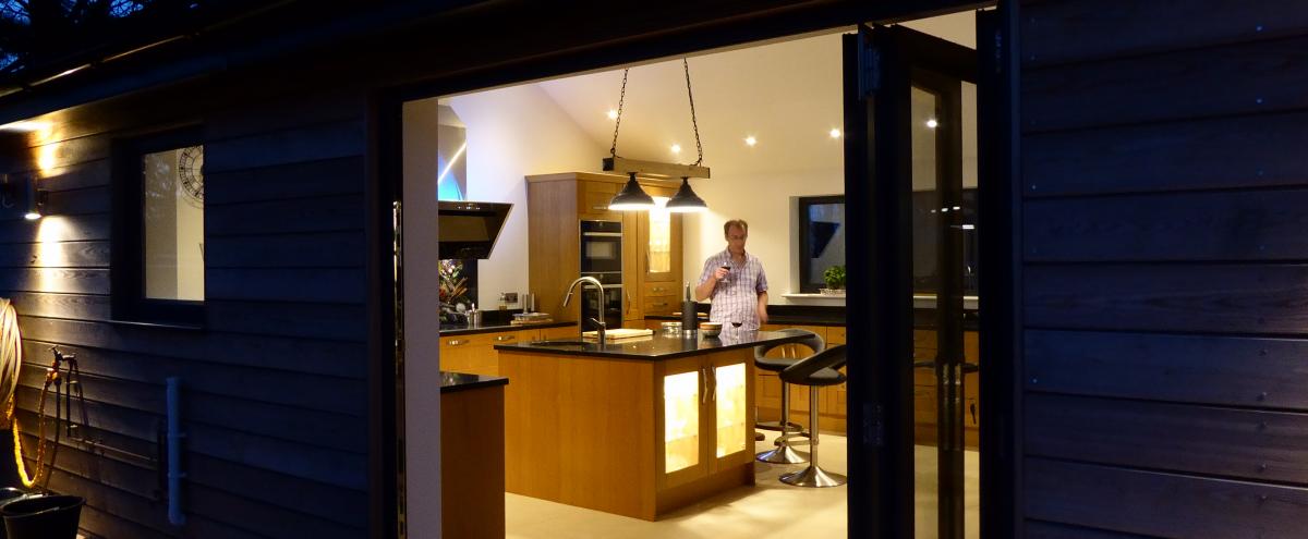Kitchen bi-fold doors bringing the outside in, with low profile threshold